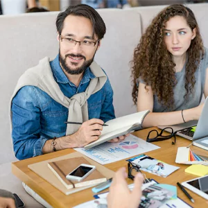 people pointing at a white table